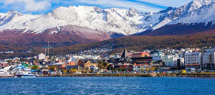 Snow-capped mountains behind the village of Ushuaia | Buenos Aires •  expedition cruise with Ushuaia, Drake Passage, the Antarctic Peninsula, South Georgia with Grytviken, Port Stanley & the Falkland Islands • Buenos Aires 
