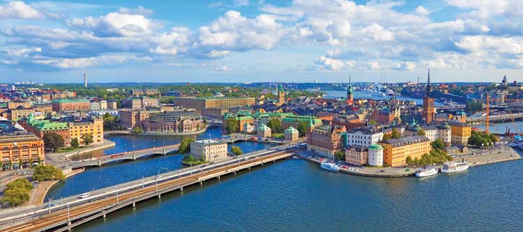 Panoramic aerial view over the blue summer skies above the iconic waterfront of Gamla Stan and Sodermalm in the heart of Stockholm, Sweden's vibrant capital city