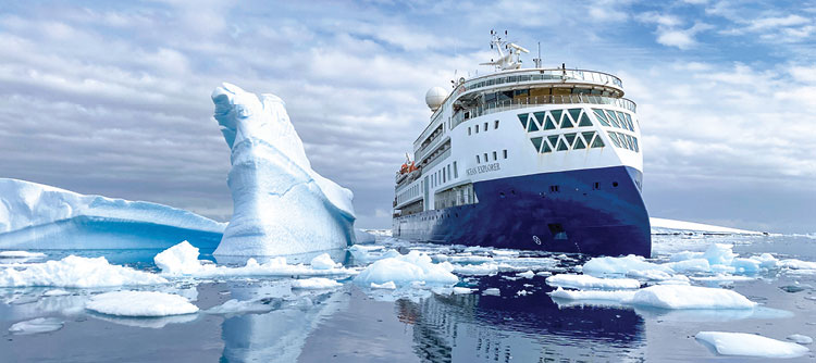 Ocean Explorer sailing through the blue glaciers of Antarctica