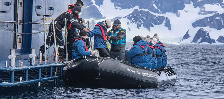 Passengers boarding a zodiac boat next to the Ocean Explorer, Antarctica