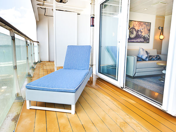 Ocean Explorer, Category ES, Explorer Suite, Balcony with lounge chair and view into living area