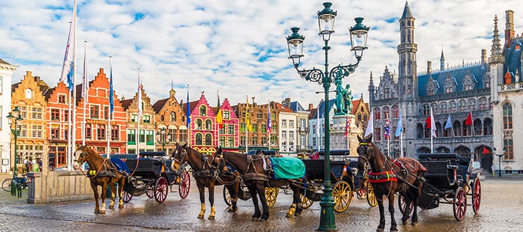 Horse-draw carriages in historic city square, Brugge, Brussels, Belgium