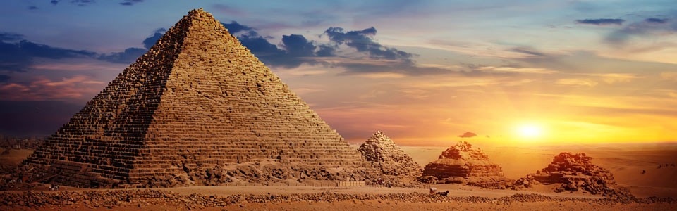 The sun sets behind the pyramids of Giza outside of Cairo, Egypt